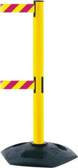 Tensator - 38" High, 2-1/2" Pole Diam, 4 Way Stanchion - 19" Base Diam, Octagon Recycled Rubber Base, Yellow Plastic Post, 7-1/2' x 2" Tape, Dual Line Tape, For Outdoor Use - Makers Industrial Supply