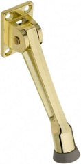 National Mfg. - 5" Projection Kickdown Door Stop - Screw Mount, Brass Finish - Makers Industrial Supply